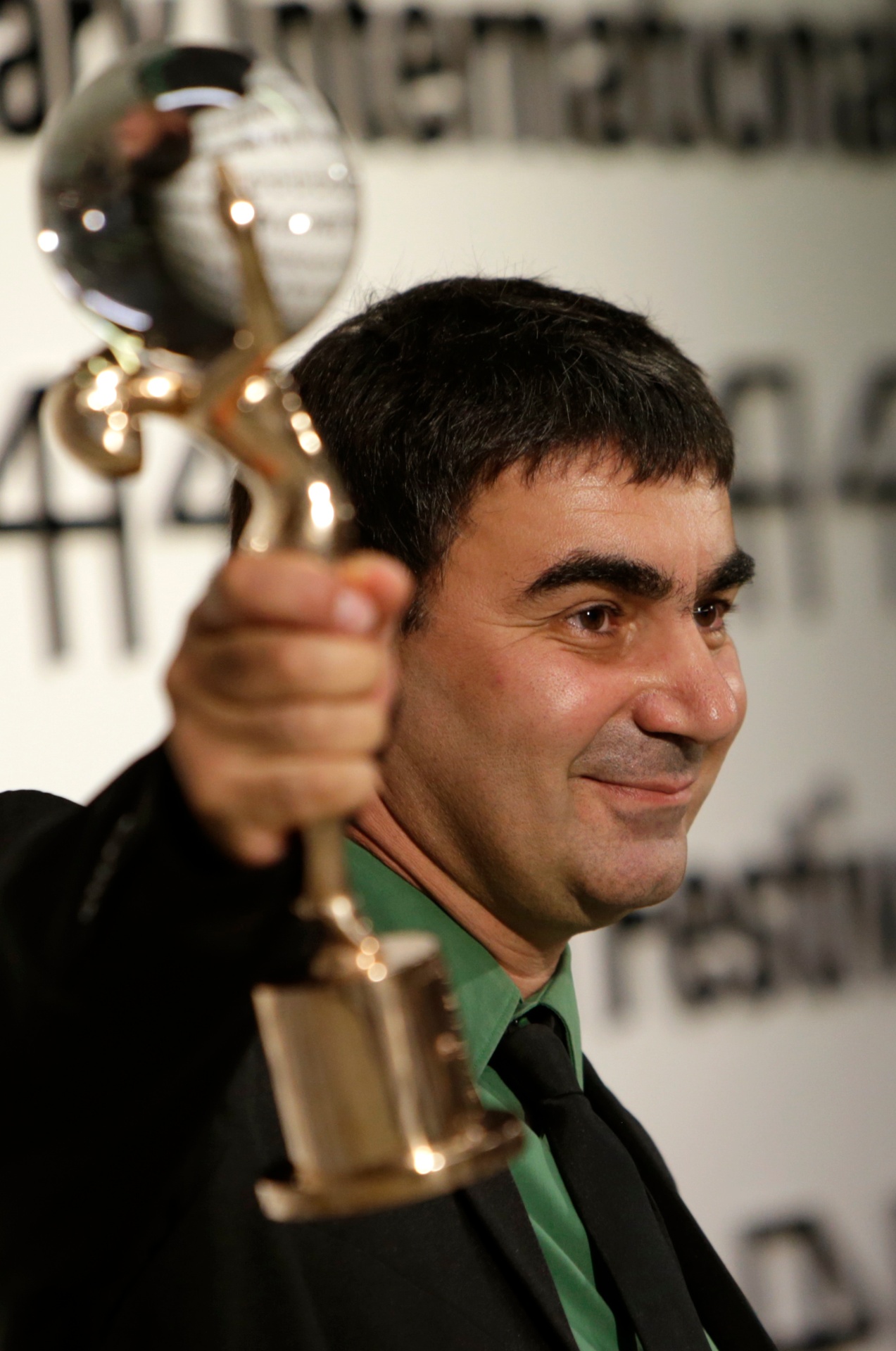 Director George Ovashvili holding an award at an international film festival
